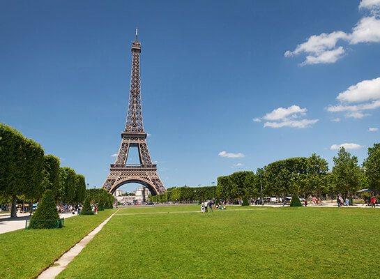 Looking up at the Eiffel Tower in Paris, France from the Champ de Mars park
